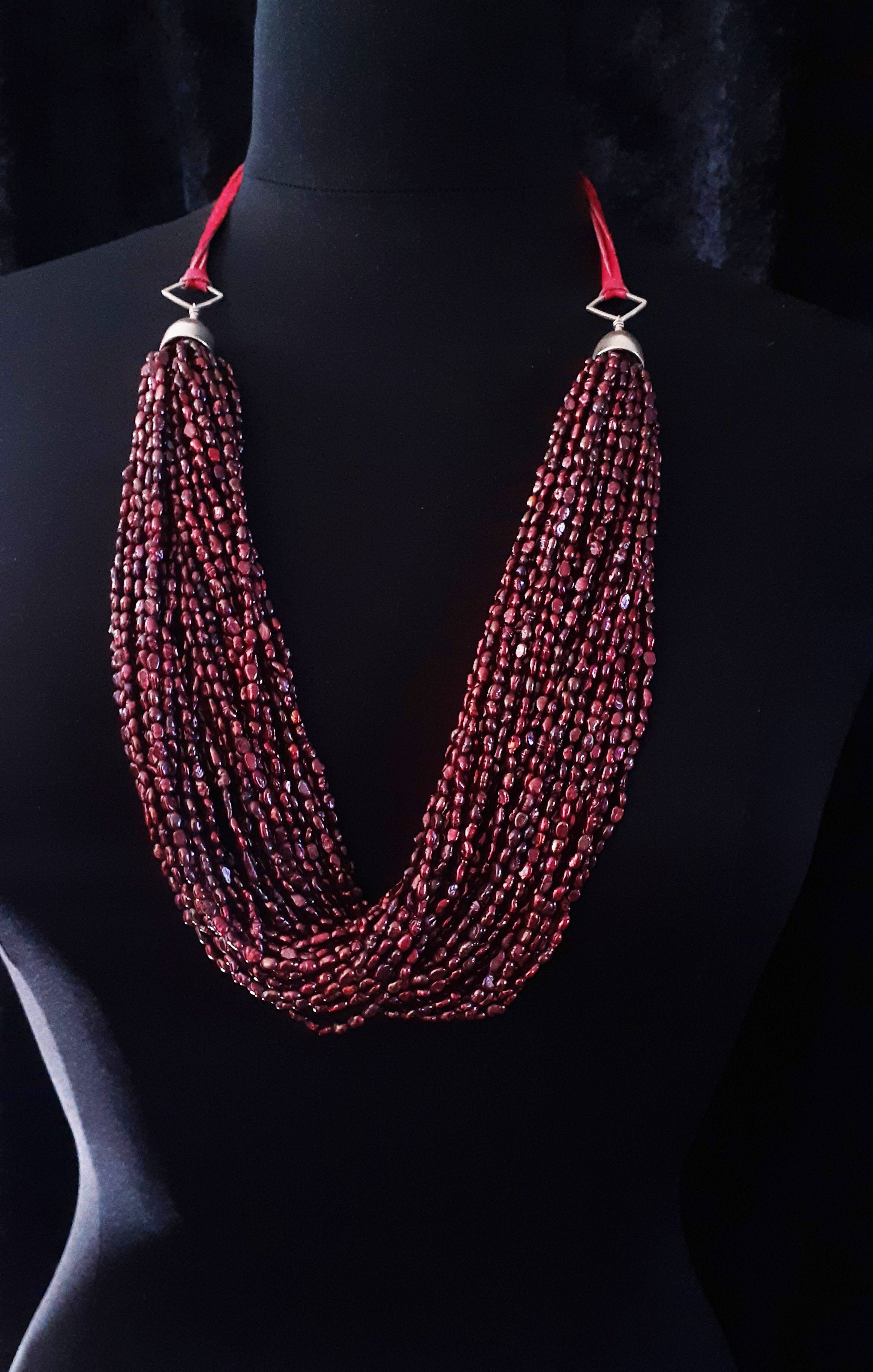 RED FRESHWATER PEARL TORSADE WITH SILVER ON PINK LEATHER